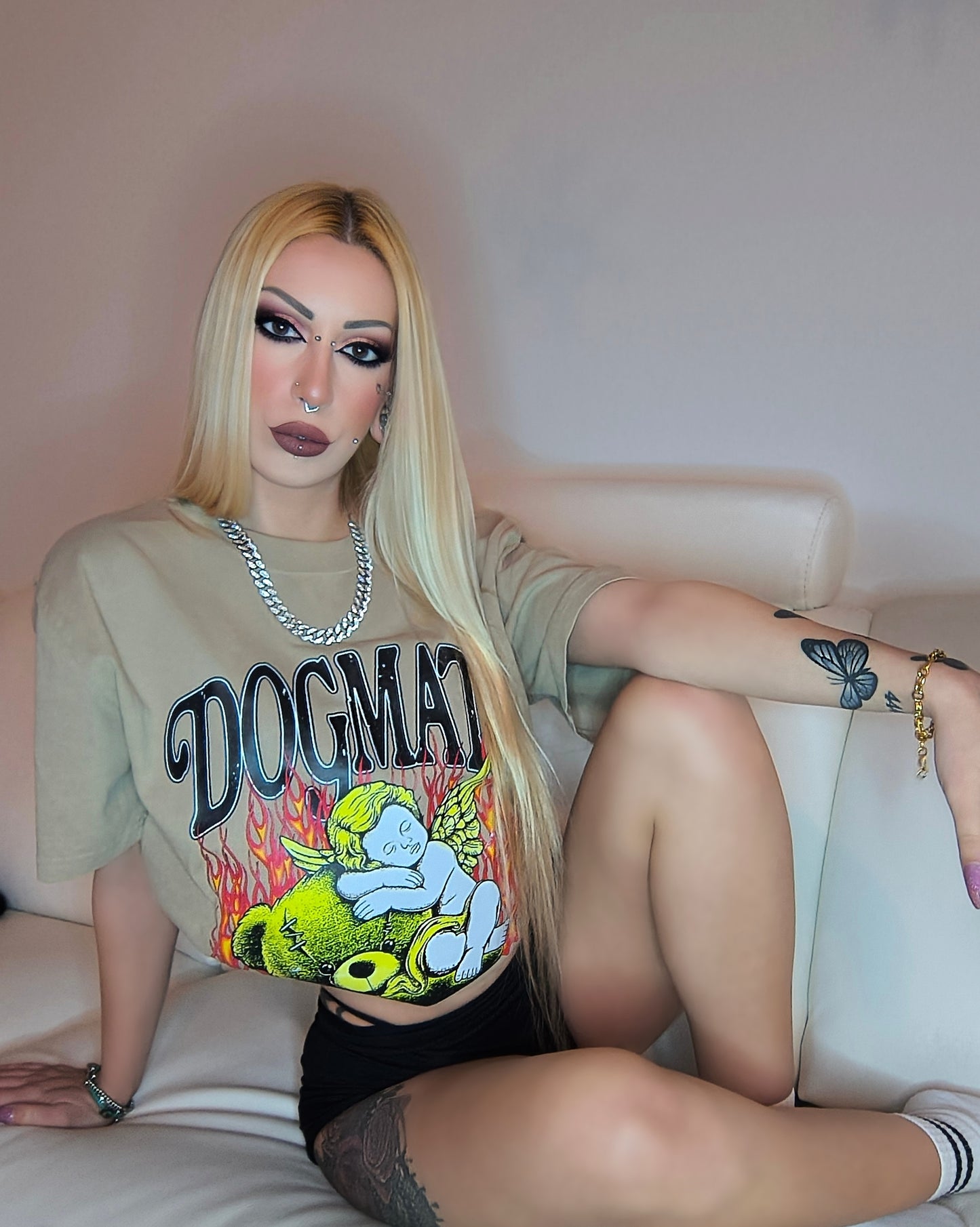Person wearing a graphic t-shirt sitting on a couch.